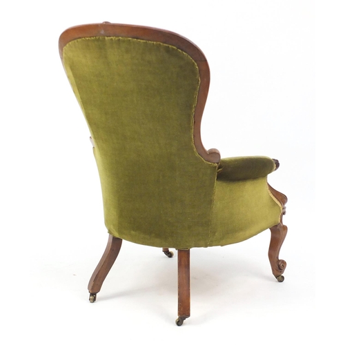 30 - Victorian carved walnut armchair with green button back upholstery, 107cm high
