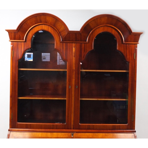 13 - Inlaid yew bureau book case, fitted with a pair of arch shaped glazed doors, above a fall and four d... 