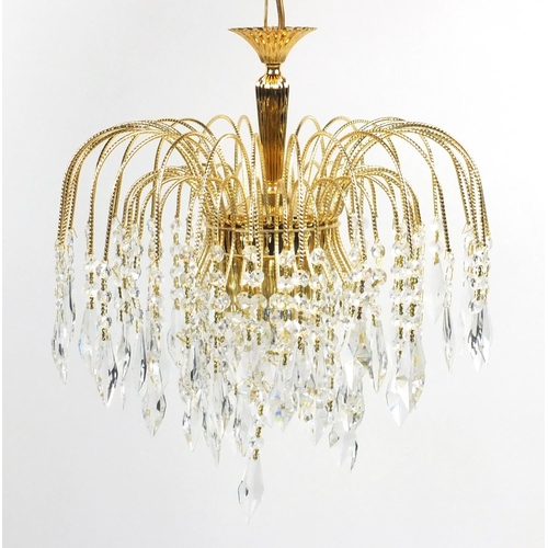 52 - Ornate brass three tier chandelier with crystal drops, 36cm in diameter