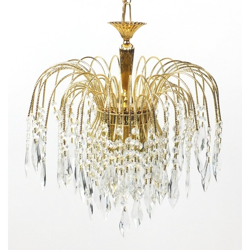 52 - Ornate brass three tier chandelier with crystal drops, 36cm in diameter