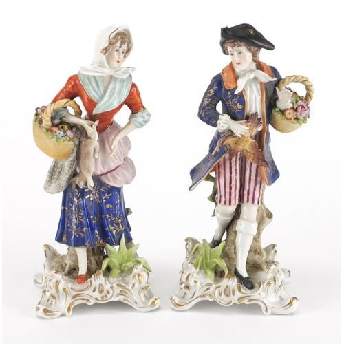 2095 - Pair of continental porcelain figures of a man and a lady carrying game, 18cm high