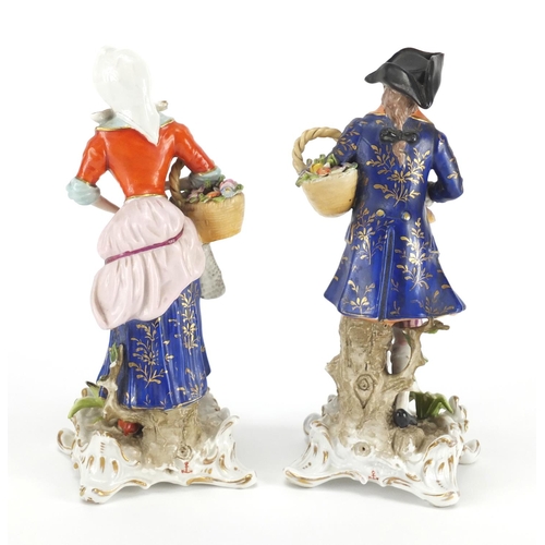 2095 - Pair of continental porcelain figures of a man and a lady carrying game, 18cm high