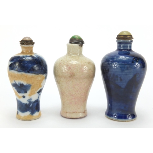 692 - Three Chinese porcelain and stoneware snuff bottles with stoppers of Meiping form, two hand painted ... 