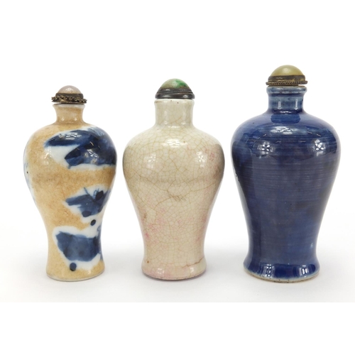 692 - Three Chinese porcelain and stoneware snuff bottles with stoppers of Meiping form, two hand painted ... 