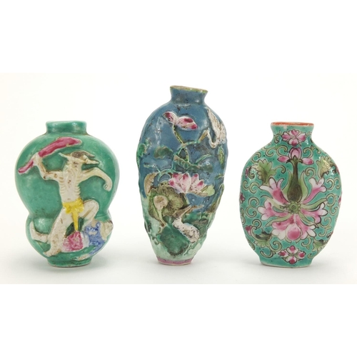 691 - Three Chinese porcelain turquoise ground snuff bottles, comprising two relief examples and one hand ... 