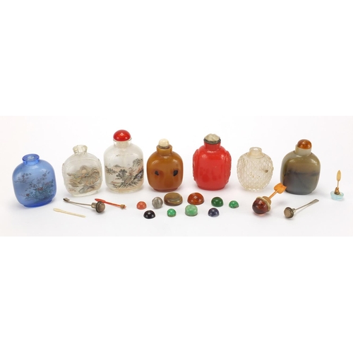 689 - Seven Chinese hardstone and glass snuff bottles together with a group of stoppers, including reverse... 