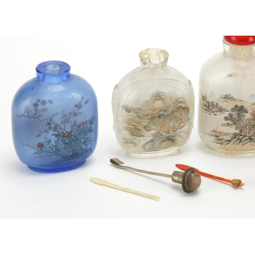 689 - Seven Chinese hardstone and glass snuff bottles together with a group of stoppers, including reverse... 