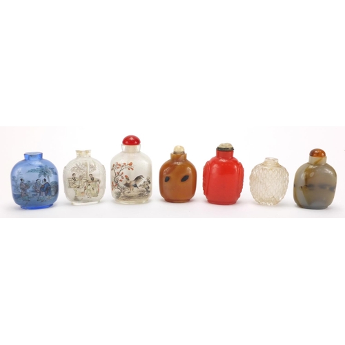 689 - Seven Chinese hardstone and glass snuff bottles together with a group of stoppers, including reverse... 