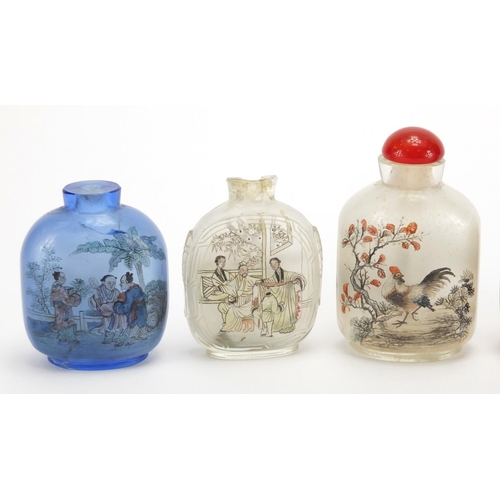 689 - Seven Chinese hardstone and glass snuff bottles together with a group of stoppers, including reverse... 