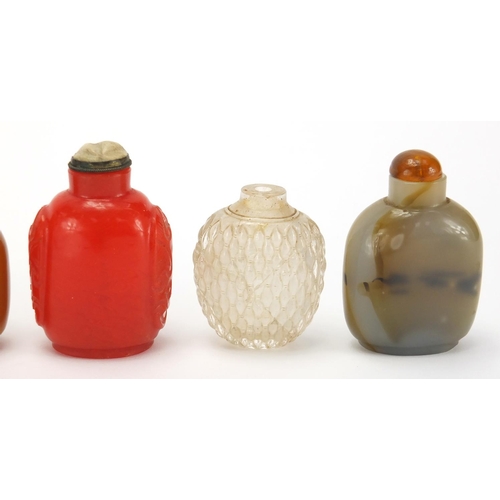 689 - Seven Chinese hardstone and glass snuff bottles together with a group of stoppers, including reverse... 