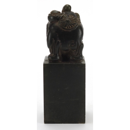 709 - Chinese green hardstone desk seal carved with a figure and elephant, 14.5cm high
