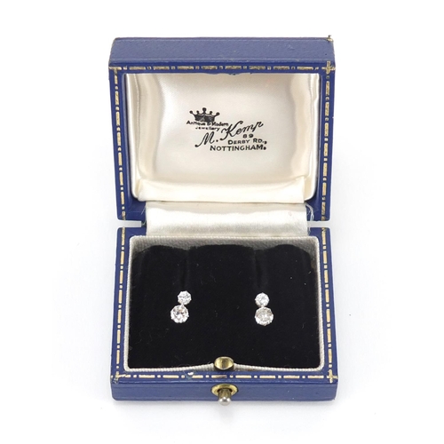 1050 - Pair of unmarked white metal diamond stud earrings,  9mm in length, approximate weight 1.8g, housed ... 