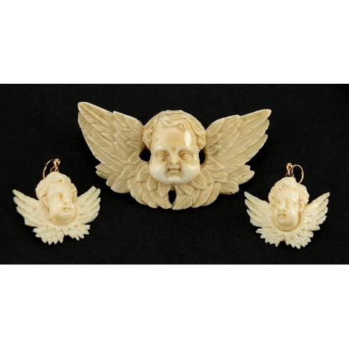 1074 - Well detailed Victorian carved ivory cherub pendant and similar earrings, the pendant 6.5cm wide, ap... 