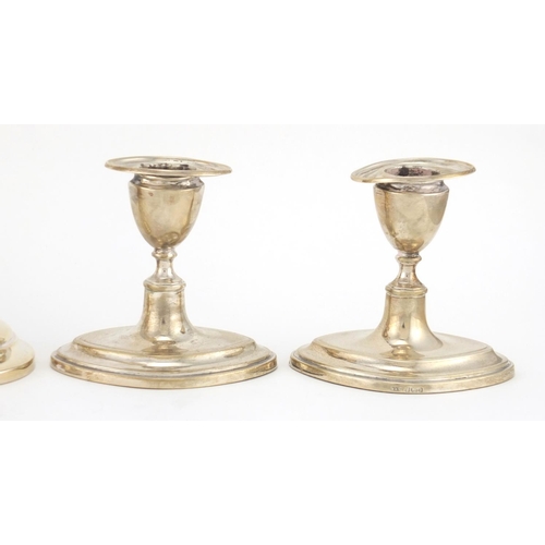 216 - Two pairs of silver candlesticks and one other, various Birmingham and Sheffield hallmarks, the larg... 