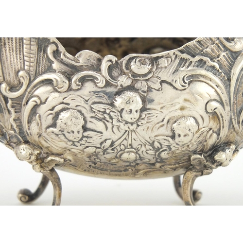 189 - French silver sauce boat, profusely embossed with cherubs and flowers, raised on scroll feet, indist... 