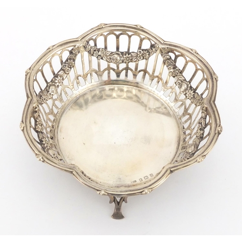 209 - Circular silver four footed bon bon dish with pierced decoration and floral swags, by S & Co, Birmin... 