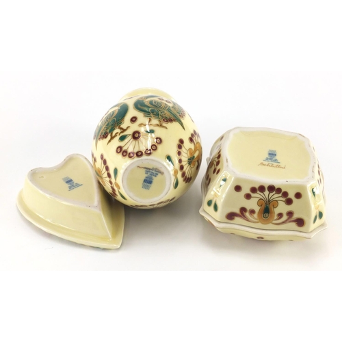 1006 - Zsolnay Pecs porcelain comprising a pot and cover, vase and heart shaped pin dish, housed in a fitte... 