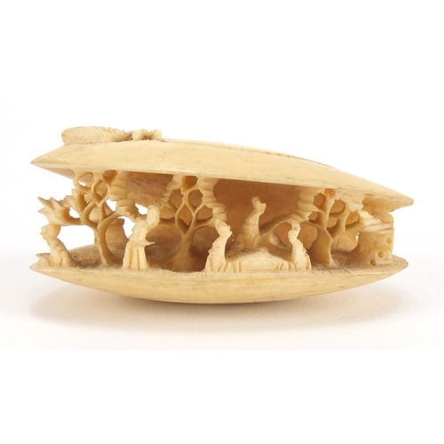 717 - Japanese ivory clamshell internally carved with figures, 7cm wide