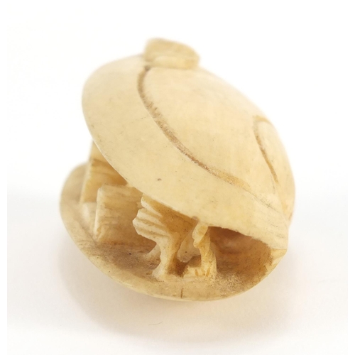 717 - Japanese ivory clamshell internally carved with figures, 7cm wide