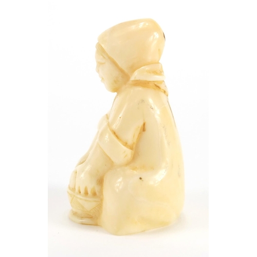 55 - Dieppe carved ivory figure of a young girl washing, incised numbers to the base, 6.5cm high