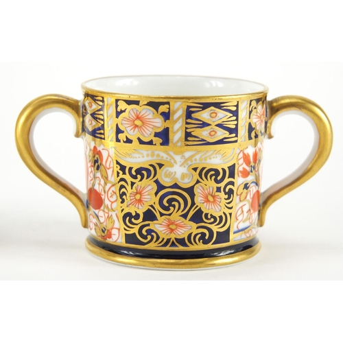 819 - Miniature Royal Crown Derby Imari twin handled loving cup and a saucer, each with factory marks to t... 