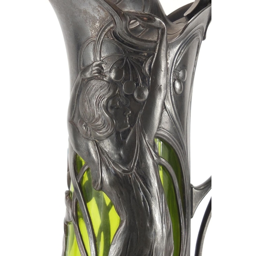 1019 - Art Nouveau pewter and green glass lined ewer by WMF, the pewter body cast with a stylised maiden, i... 