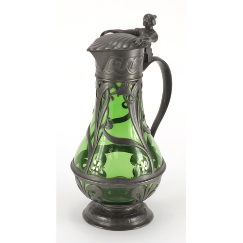 1020 - Art Nouveau pewter and green glass lined ewer in the style of WMF, the pewter body cast with stylise... 