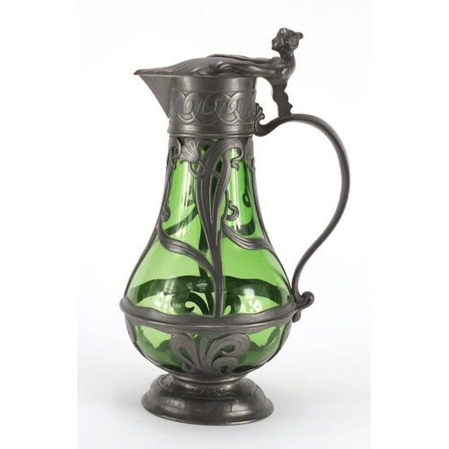 1020 - Art Nouveau pewter and green glass lined ewer in the style of WMF, the pewter body cast with stylise... 