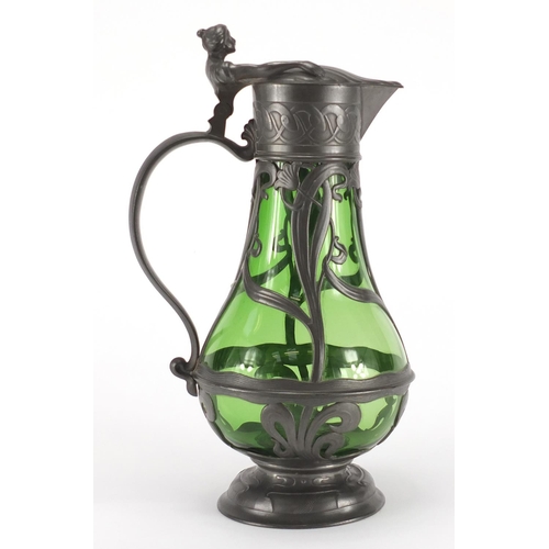 1020 - Art Nouveau pewter and green glass lined ewer in the style of WMF, the pewter body cast with stylise... 