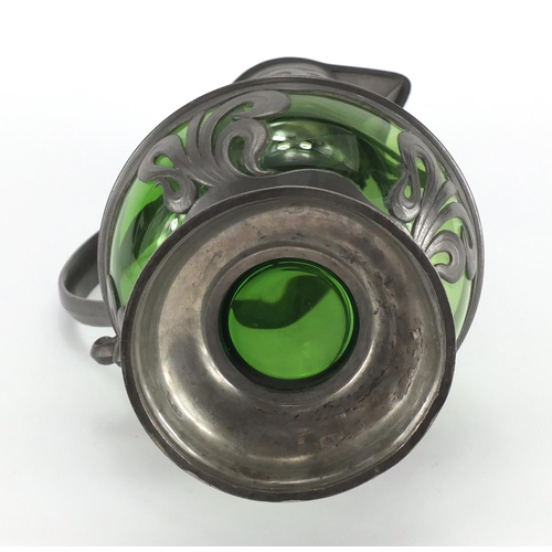 1020 - Art Nouveau pewter and green glass lined ewer in the style of WMF, the pewter body cast with stylise... 