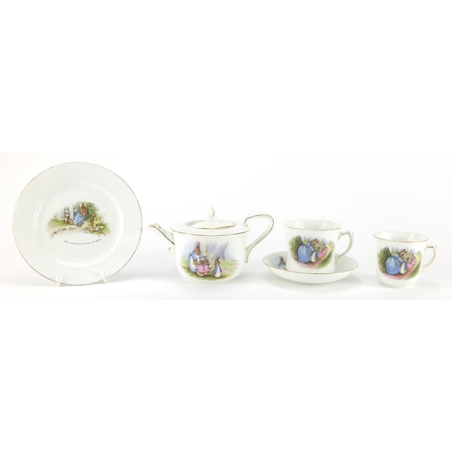 978 - Peter Rabbit nursery teaware by Grimwades comprising teapot, two cups, a saucer and side plate, the ... 