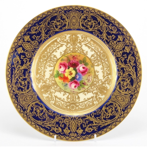 806 - Royal Worcester cabinet plate hand painted with flowers by J Stanley, within gilt foliate borders on... 