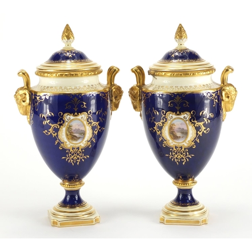 830 - Pair of Coalport vases and covers with twin rams head handles, each hand painted with panels of land... 