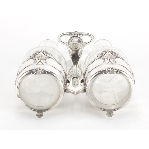 1025 - Art Nouveau Silver plated condiment set by WMF, housing a pair of cut glass bottles with stoppers, e... 