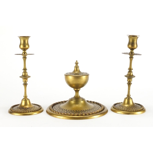 92 - 19th century gilt brass desk set comprising an inkwell and pair of candlesticks, each with chased de... 