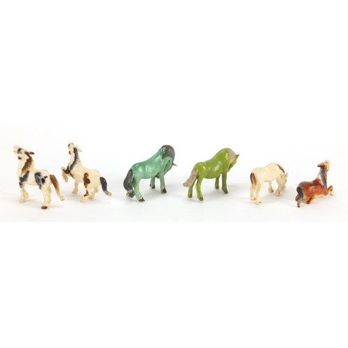 721 - Four Chinese carved ivory horses and two porcelain examples, the largest 6cm in length