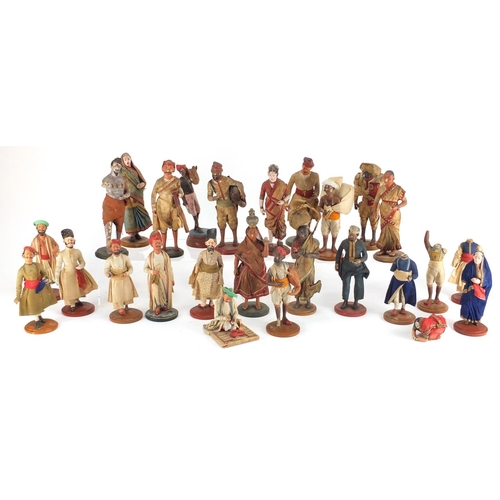 493 - Collection of mostly hand painted pottery figures, some raised on wooden plinth bases, the largest a... 