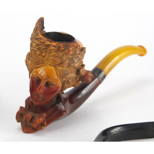 48 - Five antique and later pipes including including a Blackamoors head and Meerschaum example with maid... 