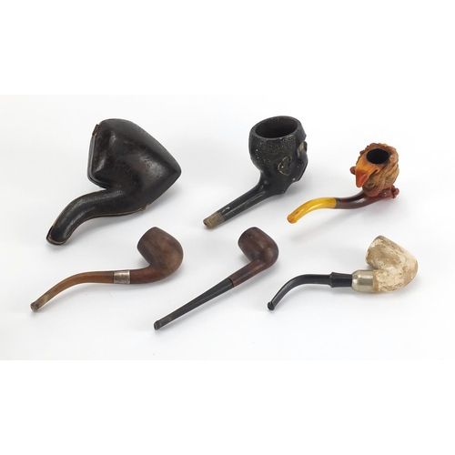 48 - Five antique and later pipes including including a Blackamoors head and Meerschaum example with maid... 