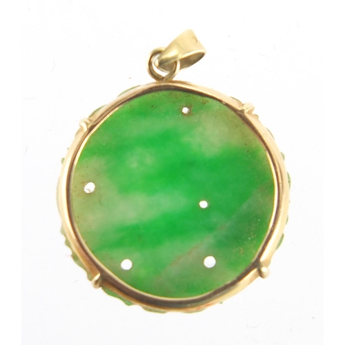 696 - Chinese 14ct gold and green jade pendant carved with a flower, 2cm in diameter, approximate weight 2... 