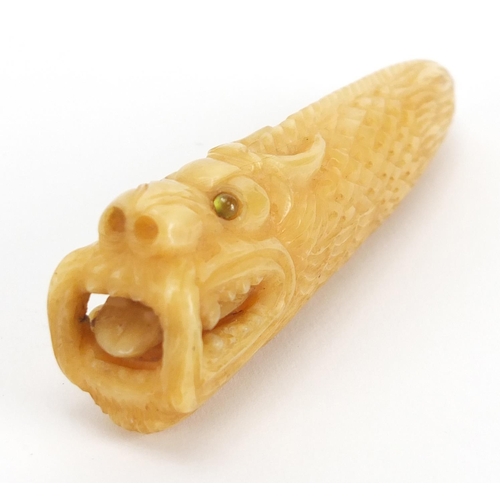 719 - Chinese vegetable ivory carving of a dragons head, with inset eyes, character marks to the underside... 