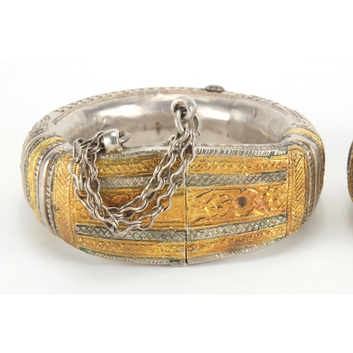 743 - Pair of Middle Eastern, probably Oman, partially gilt unmarked silver anklets, engraved with stylise... 