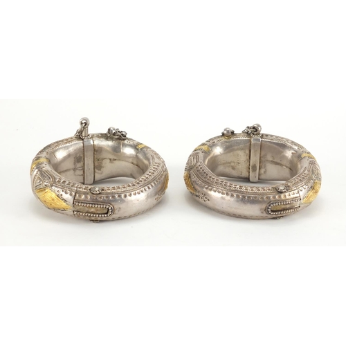 743 - Pair of Middle Eastern, probably Oman, partially gilt unmarked silver anklets, engraved with stylise... 