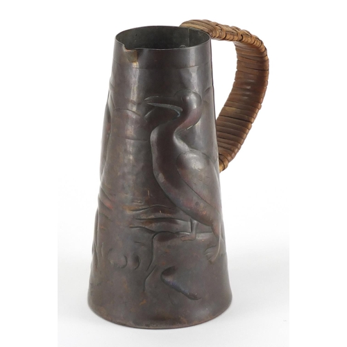 1032 - Arts & Crafts Newlyn School copper jug, the tapering body embossed with two birds, 15cm high