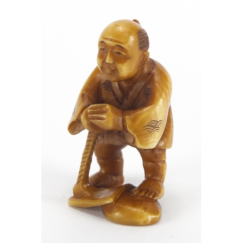 718 - Japanese carved ivory Netsuke of a fisherman, character marks to the base, 4.5cm high