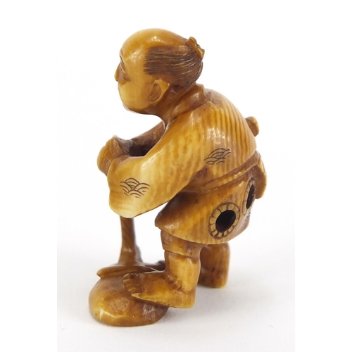 718 - Japanese carved ivory Netsuke of a fisherman, character marks to the base, 4.5cm high