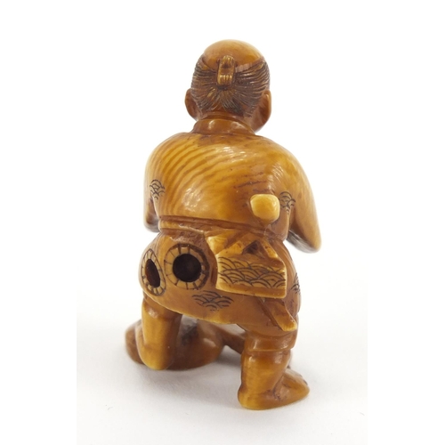 718 - Japanese carved ivory Netsuke of a fisherman, character marks to the base, 4.5cm high