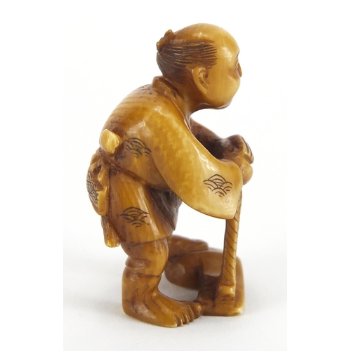 718 - Japanese carved ivory Netsuke of a fisherman, character marks to the base, 4.5cm high