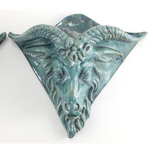 981 - Pair of blue glazed rams head design pottery wall pockets of triangular form, 26cm H x 31cm W