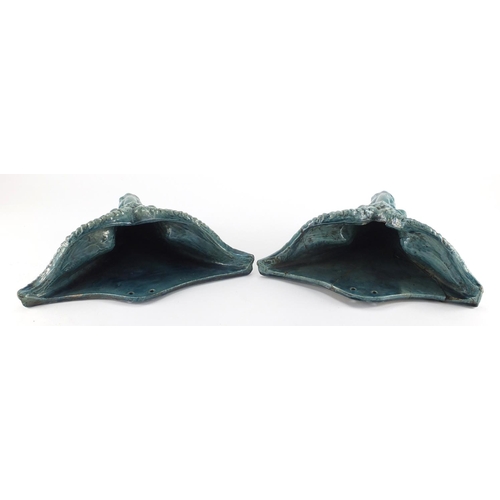 981 - Pair of blue glazed rams head design pottery wall pockets of triangular form, 26cm H x 31cm W